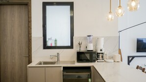 A modern kitchen with a built-in dishwasher, a coffee maker, and a microwave. - Riverbank 1-bedroom apartment in terrific Nairobi Pool & Gym (Nairobi)