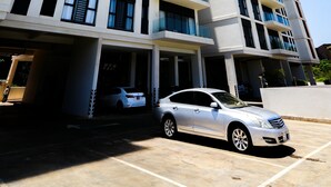 A multi-story building with a modern architectural design, featuring a series of balconies and large windows. - Riverbank 1-bedroom apartment in terrific Nairobi Pool & Gym (Nairobi)
