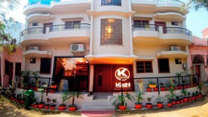 A multi-story building with a prominent sign reading "Kushi". - THE KASHI RESIDENCY  (Varanasi)