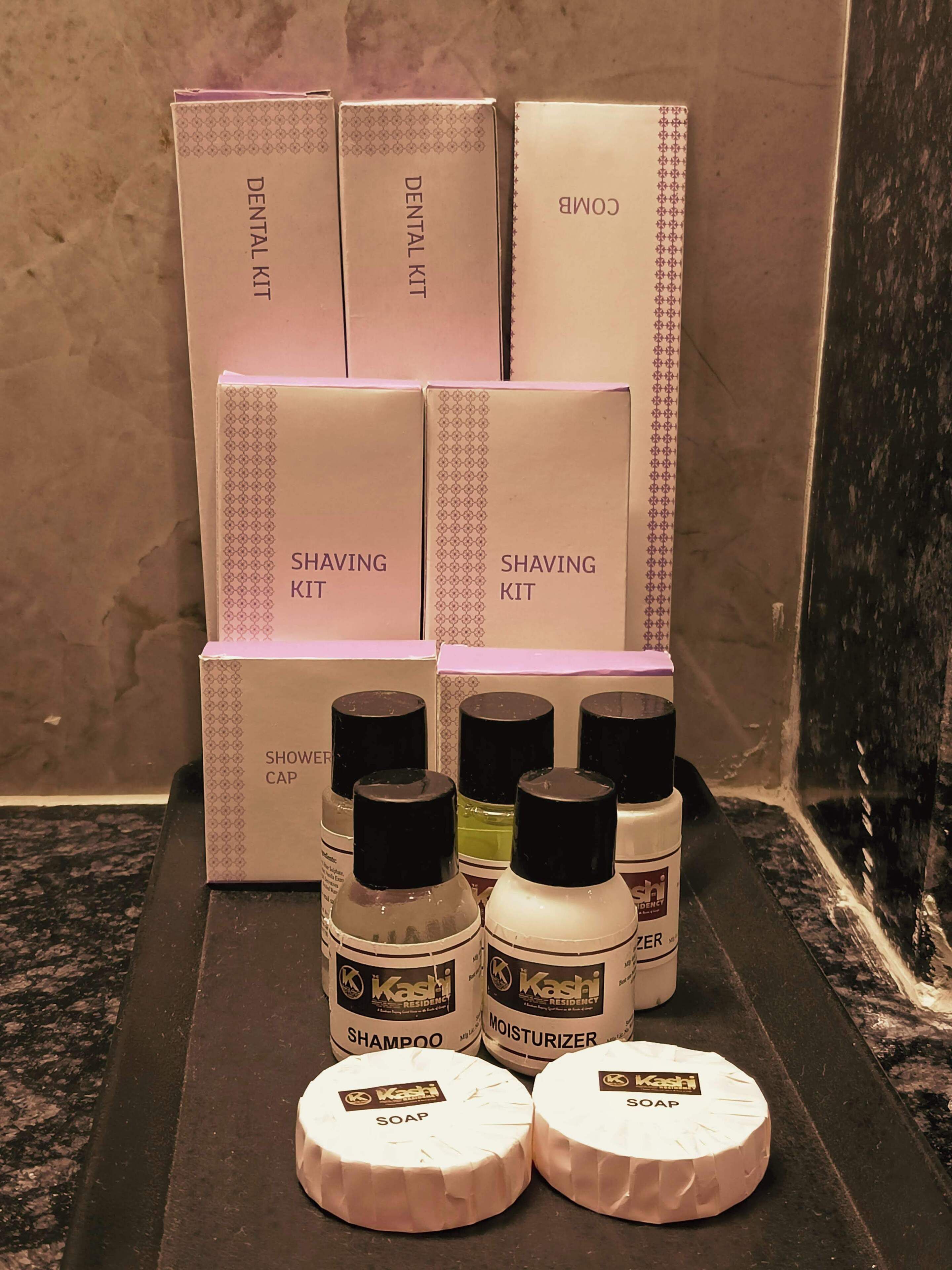 A display of grooming products including shaving kits, a shower cap, shampoo, and soap.