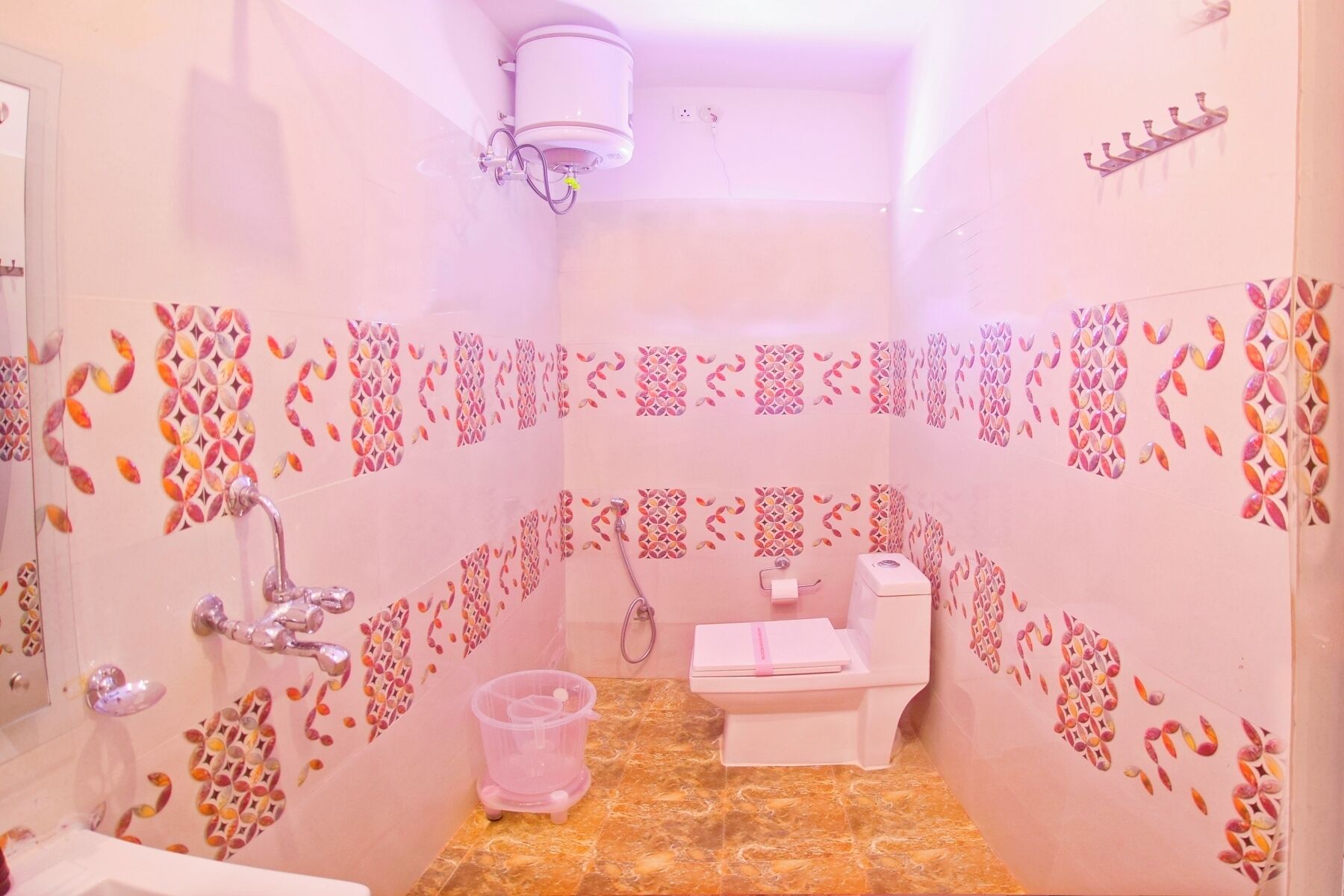 A bathroom with a toilet, sink, and shower area.