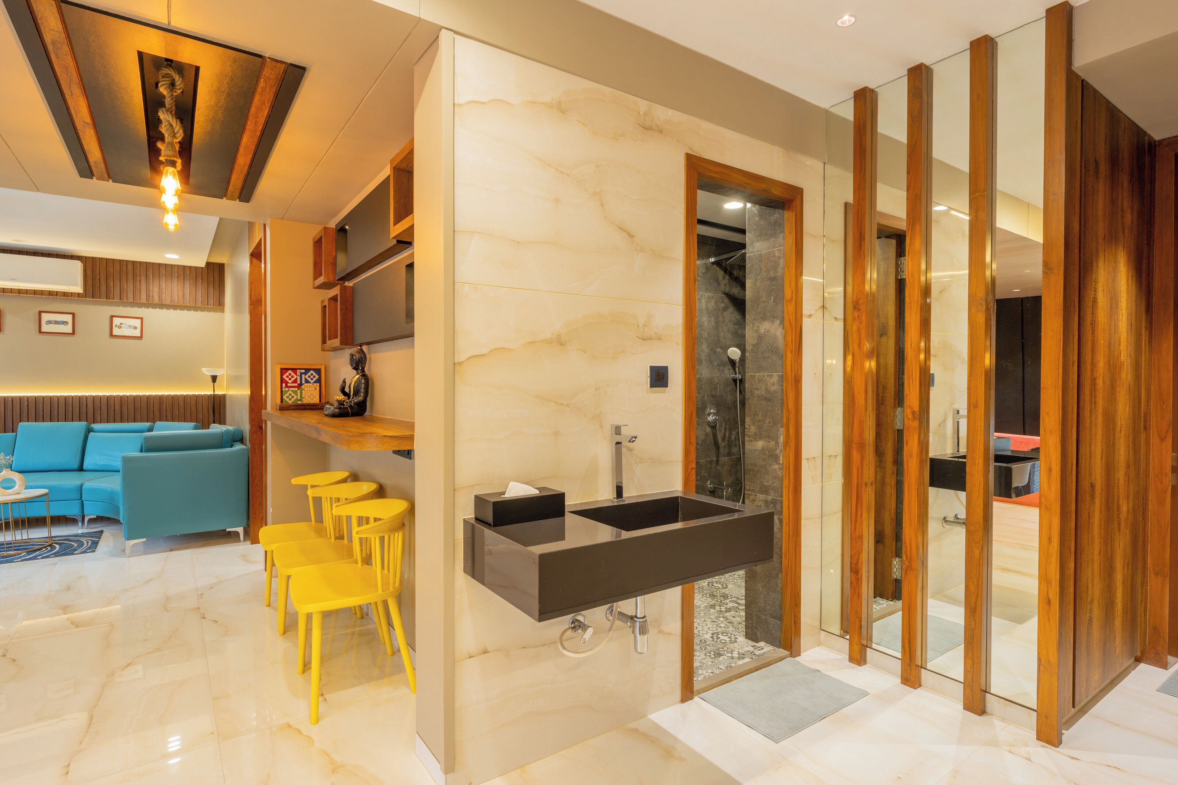 A modern bathroom with a large sink, a shower, and a glass partition.