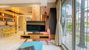 Family Room, Balcony, City View | Living room | TV