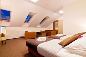 A hotel room with two beds, a desk, a chair, and a window with a view of a snowy landscape. - Dolina Leśnicy SKI & SPA Resort (Brenna)