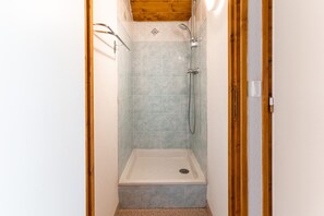 A small, enclosed shower area with a wooden ceiling and tiled walls. - 150m from the slopes, apartment for 8 with balcony (Le Dévoluy)