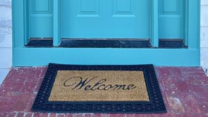 A teal-colored front door with a small window and a doorbell. - The Majestic View / Luxury Stay Gulf Course Views / 4-Bedroom House (Bloomfield)