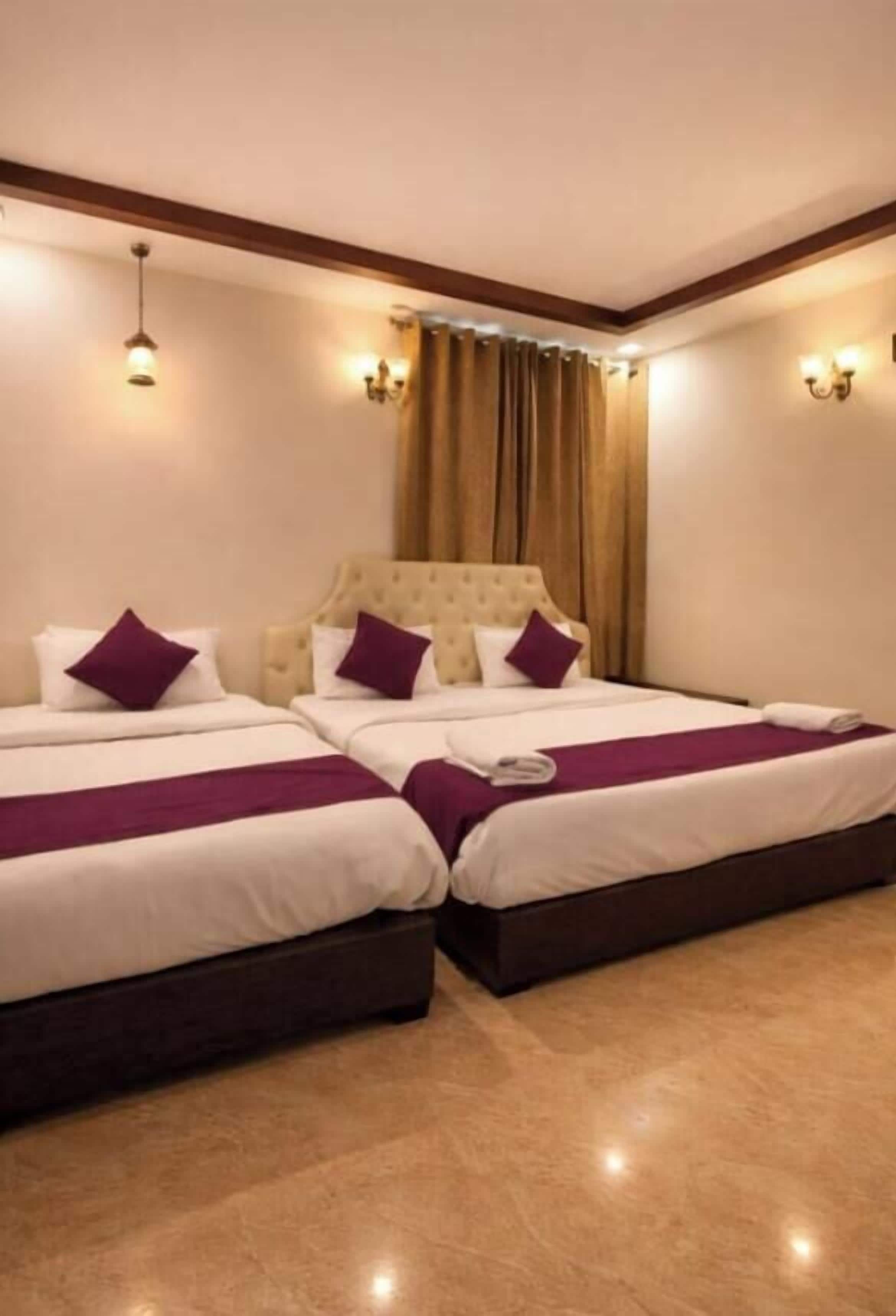 A hotel room with two beds, a tufted headboard, and a marble floor.