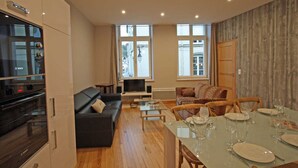A modern apartment with a kitchen, living area, and dining space.