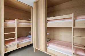 A room with two bunk beds, wooden walls, and a slatted partition. - Geneva Youth Hostel (Vernier)