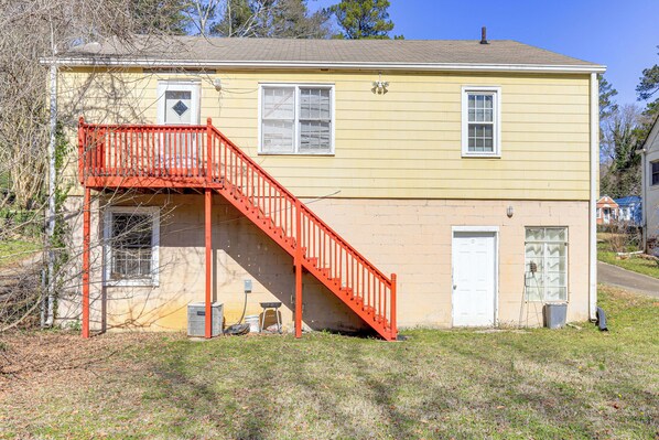 A two-story building with a red staircase leading to a balcony.
