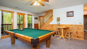 A pool table with a ceiling fan, wooden chairs, a small table, and a staircase. - Hot Tub & Game Room: Log Cabin 2 Mi to Ripleys! (Gatlinburg)