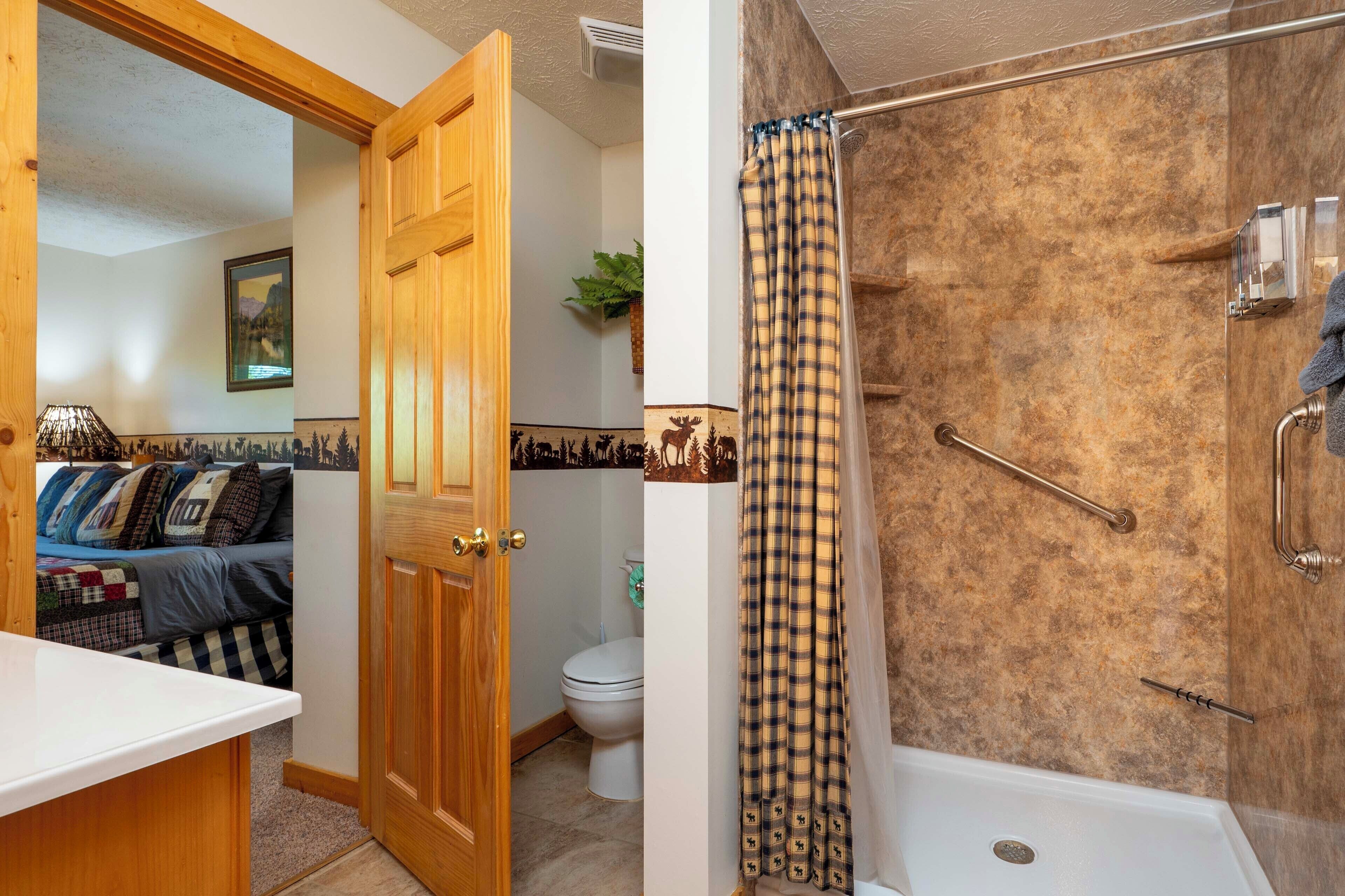 A bathroom with a shower, toilet, and sink.