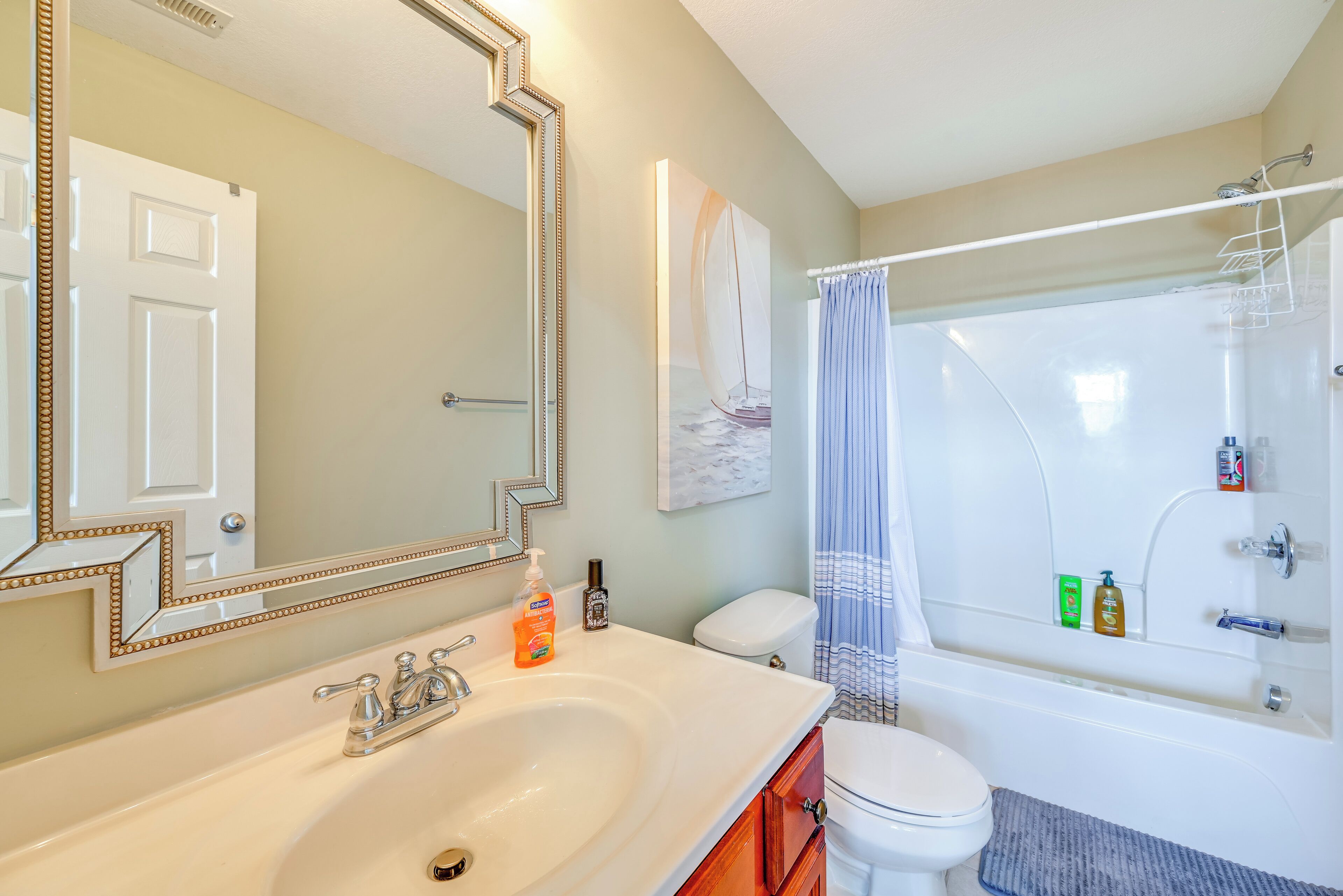 A bathroom with a sink, toilet, and bathtub.
