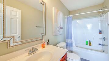 A bathroom with a sink, toilet, and bathtub.