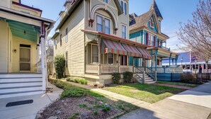 A two-story house with a porch and a small staircase leading to the second floor. - Walk to Beach: Cape May Home w/ Screened Patio! (Cape May)