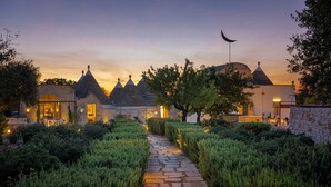 A stone pathway leading to a building with multiple pointed roofs and a crescent moon flag.