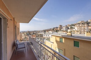 A balcony with a view of a cityscape, including buildings and a clear sky. - Goethe Charming Home by Wonderful Italy (Sanremo)
