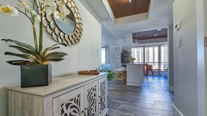 A modern living room with a wooden floor, a decorative mirror, and a potted plant. - Superbly updated ocean view condo, 303 Brighton, full access (Myrtle Beach)