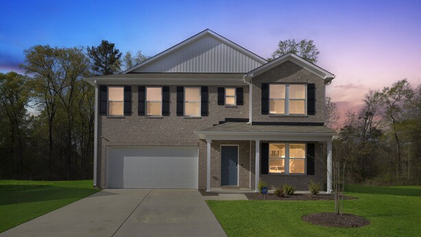 A two-story house with a garage, a front porch, and a well-maintained lawn. - Quiet Retreat Perfect for Families 5 Bedroom Home (Rocky Mount)