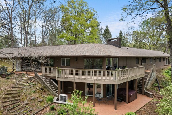 Relax on the upper-level balcony with a serene view of the surrounding natural landscape.