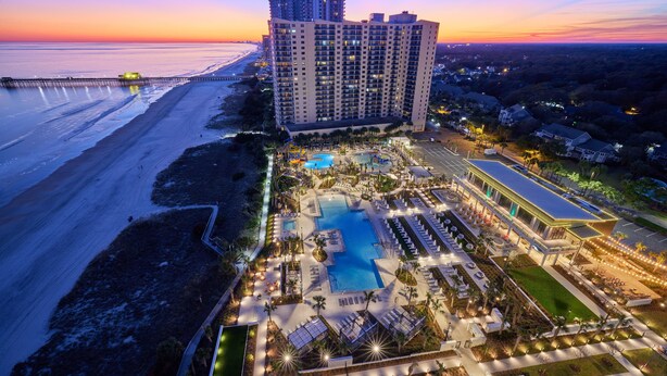A resort with a large pool, multiple swimming areas, and a beachfront view. - 1707 Brighton, impressively remodeled, 3 bedroom ocean view 3 Condo (Myrtle Beach)
