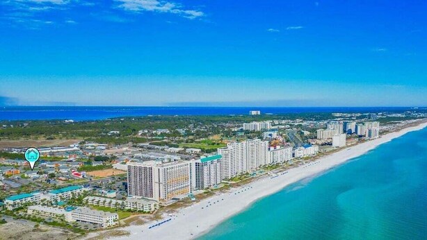 An aerial view of a coastal city with high-rise buildings, a beach, and a clear blue sky. - Boho Retreat 2003-Near Lake Aladdin-Sleeps 4 (Destin)