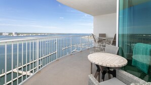 A balcony with a view of the water and cityscape. - Caribe Resort 1206B by Liquid Life (Orange Beach)