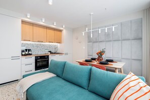 Family Apartment, City View | Living area | 50-inch Smart TV with cable channels, Netflix, streaming services - Boston by Kairos Apartments (Katowice)