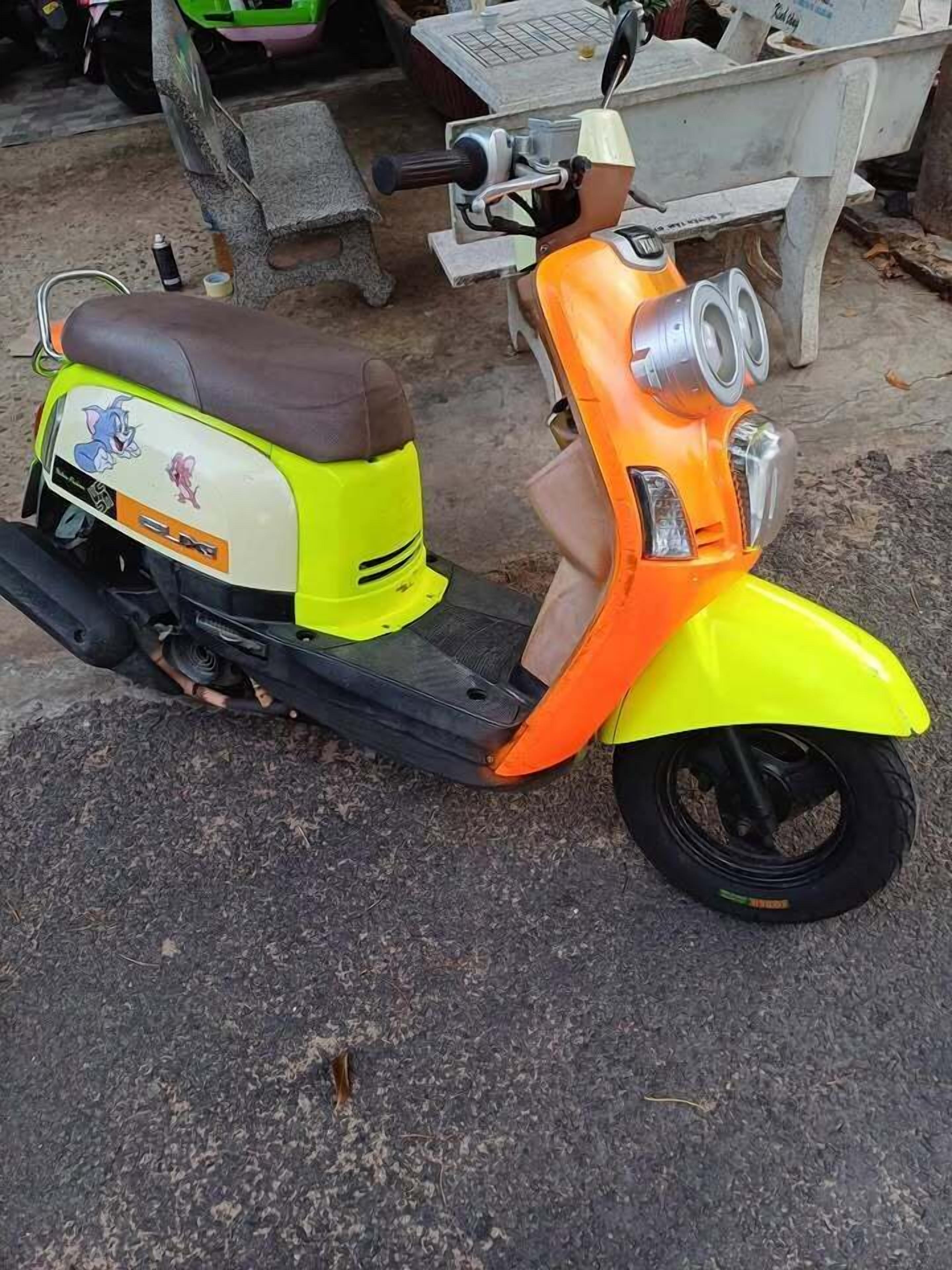 A scooter parked on a paved surface.