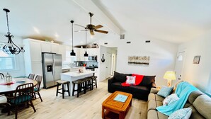 A modern apartment with a kitchen, dining area, and living room.
