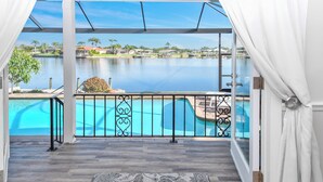 Un balcón con vistas a una piscina y un lago.
