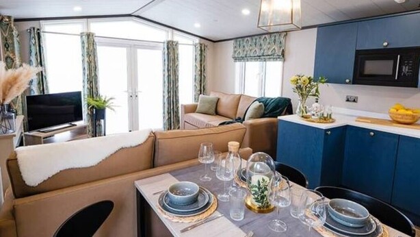 A compact living space with a dining area, kitchenette, and seating area. - Relax at Riverwood (Arbroath)