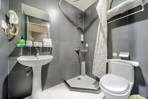 A bathroom with a pedestal sink, toilet, shower, and a mirror. - Youhai Hotel (Shanghai University Qinghe Road) (Shanghai)