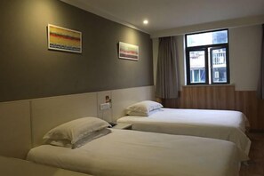A hotel room with two beds, a window with curtains, and artwork on the wall. - Youhai Hotel (Shanghai University Qinghe Road) (Shanghai)