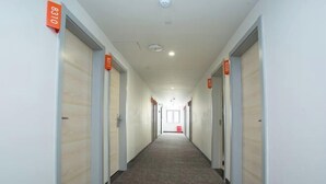 A long, narrow hallway with doors on both sides, each marked with a number. - Youhai Hotel (Shanghai University Qinghe Road) (Shanghai)