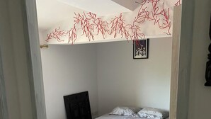 A bedroom with a bed, wooden flooring, and a white ceiling. - Very atypical downtown apartment. Old oil mill! (La Crau)