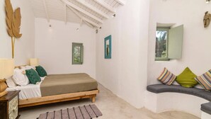 A bedroom with a bed, a nightstand, a dresser, a window, and a small balcony area. - Villa Thea by Villa Plus (Ionian Islands)