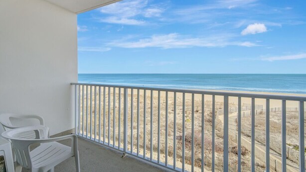 A balcony with a view of the beach and ocean. - Sea Gate 307 by Seaside Vacations & Sales (Ocean City)