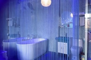A bathroom with two sinks, a mirror, and a toilet.