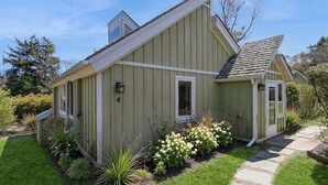 A single-story house with a gabled roof, a front porch, and a well-maintained garden.