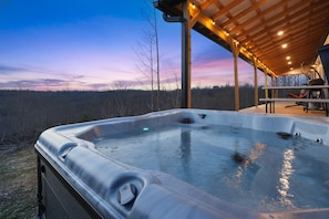 A hot tub with a wooden deck and a view of the forest. - Poplar Ridge | Hocking Hills, Sleeps 7, Hot Tub (McArthur)