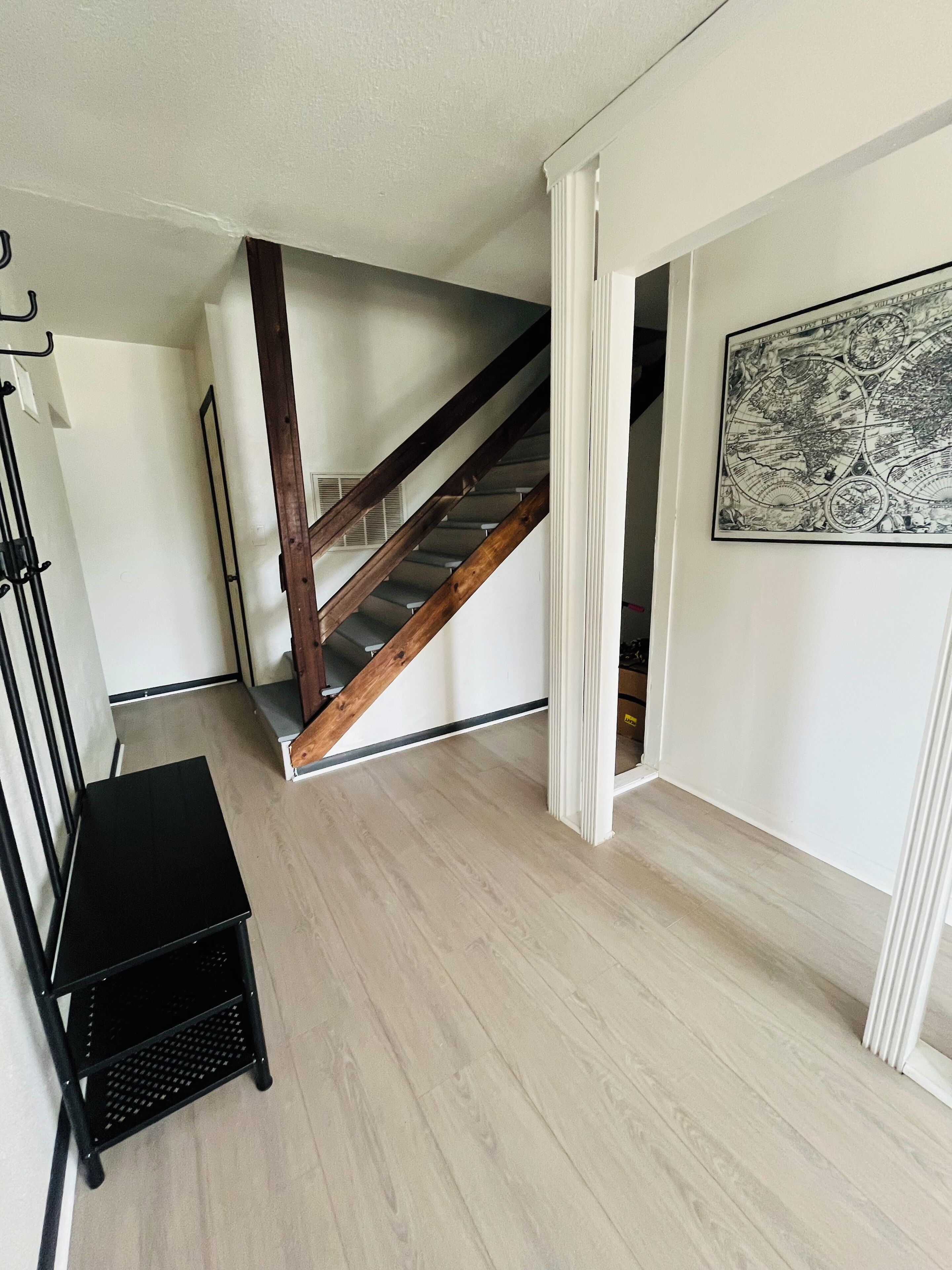 A staircase with wooden steps and a white wall.