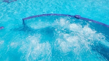 A swimming pool with clear water and a visible lane divider.