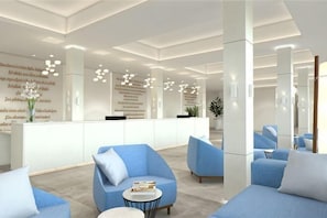 A modern lobby with blue seating, a reception desk, and a large mirror. - THB Cala Lliteras - Adults Only (Llevant)