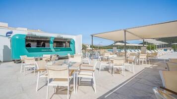 A snack bar with outdoor seating and a poolside area.