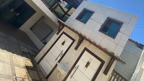 A modern building with a tiled ground floor and a flat roof. - MANSION SALE NEW (Europa Belo Horizonte)