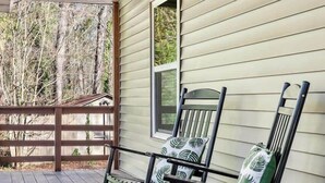 A porch with two rocking chairs, a wooden deck, and a window overlooking a wooded area. - Pet Friendly Relaxing Retreat Walk to DT|King Bed (Cary)
