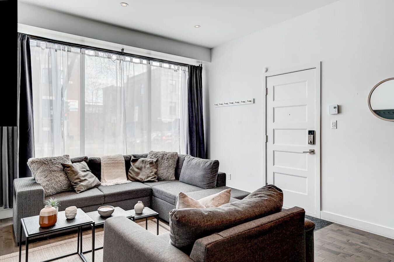 A modern living room with a sectional sofa, a coffee table, and a side table.