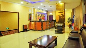A hotel lobby with a reception desk, a staircase, and seating area. - Taiyuan Baiyi Boutique Hotel (Taiyuan)
