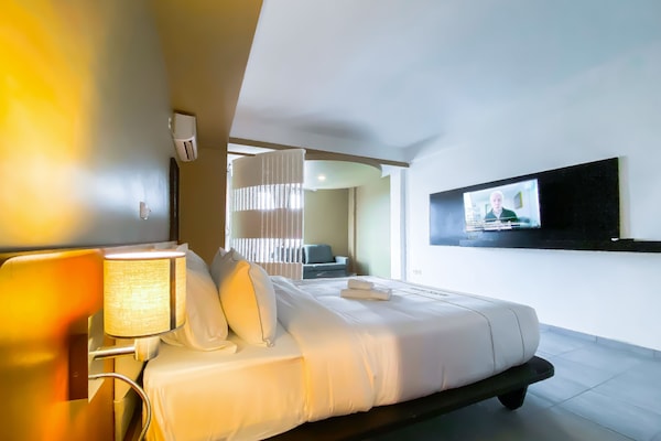 Junior Suite, Pool View | In-room safe, iron/ironing board, free WiFi